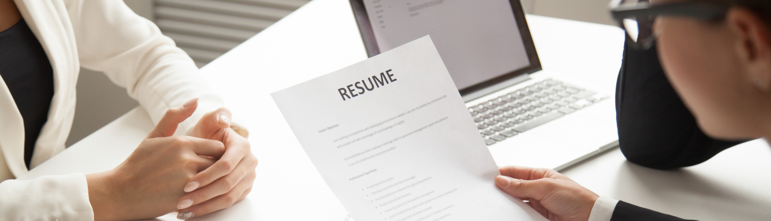 Company representatives reading applicant resume at hiring